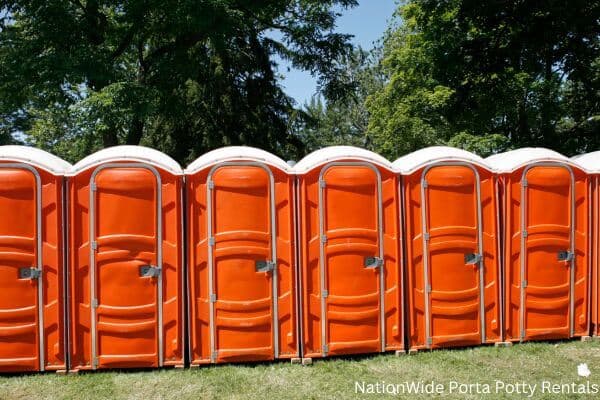 a lineup of clean and well-maintained portable loos for workers in Onawa, IA